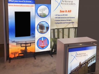 Custom modular LED backlit trade show display with vertically mounted monitor and branded backlit cabinet delivers vibrant graphics in a 10x10 booth space.