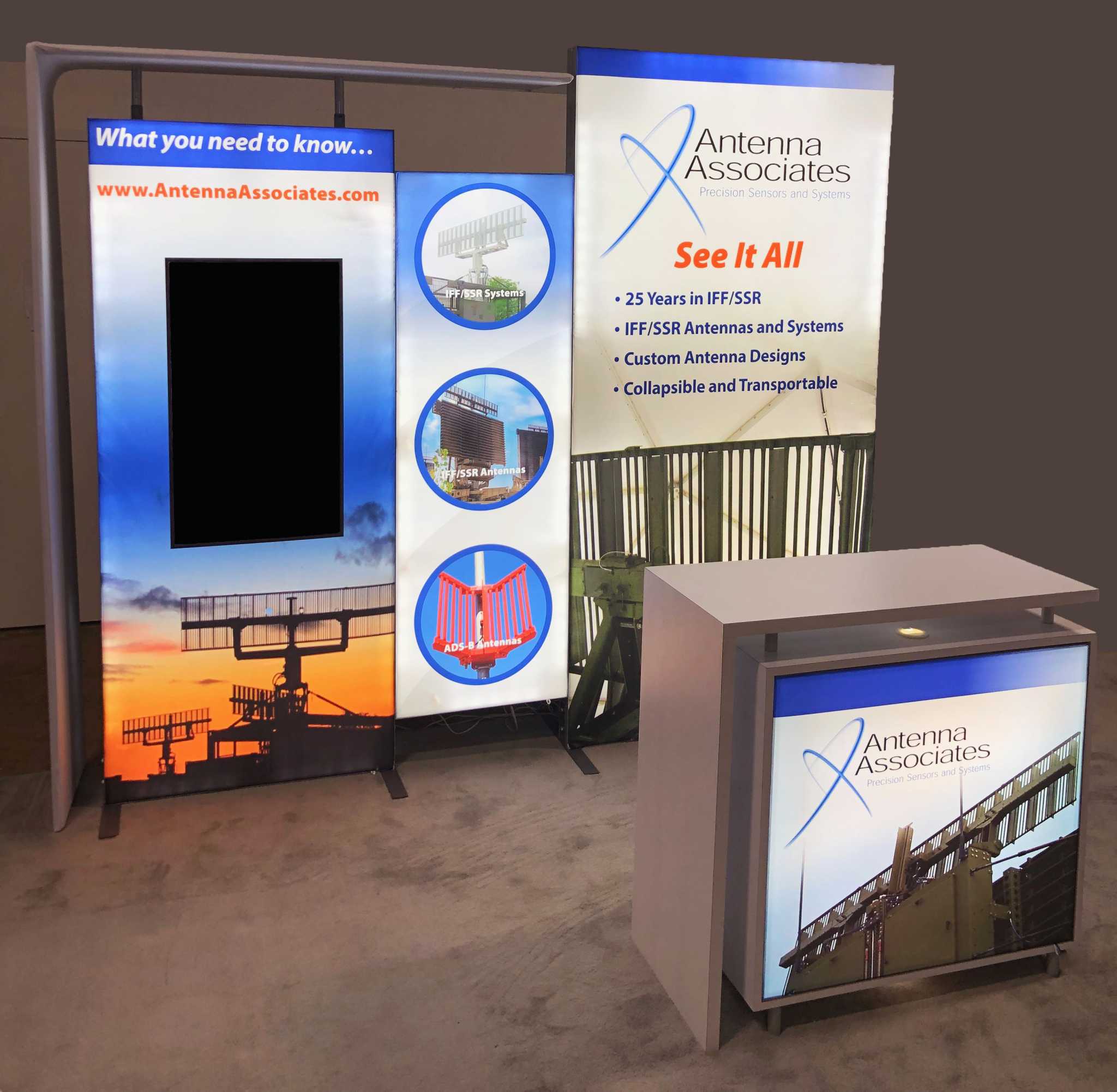 Custom modular LED backlit trade show display with vertically mounted monitor and branded backlit cabinet delivers vibrant graphics in a 10x10 booth space.