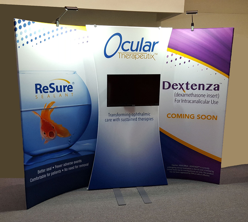 Ocular Therapeutix 10x10 curved portable fabric display with bold graphics, lighting and center fabric monitor stand